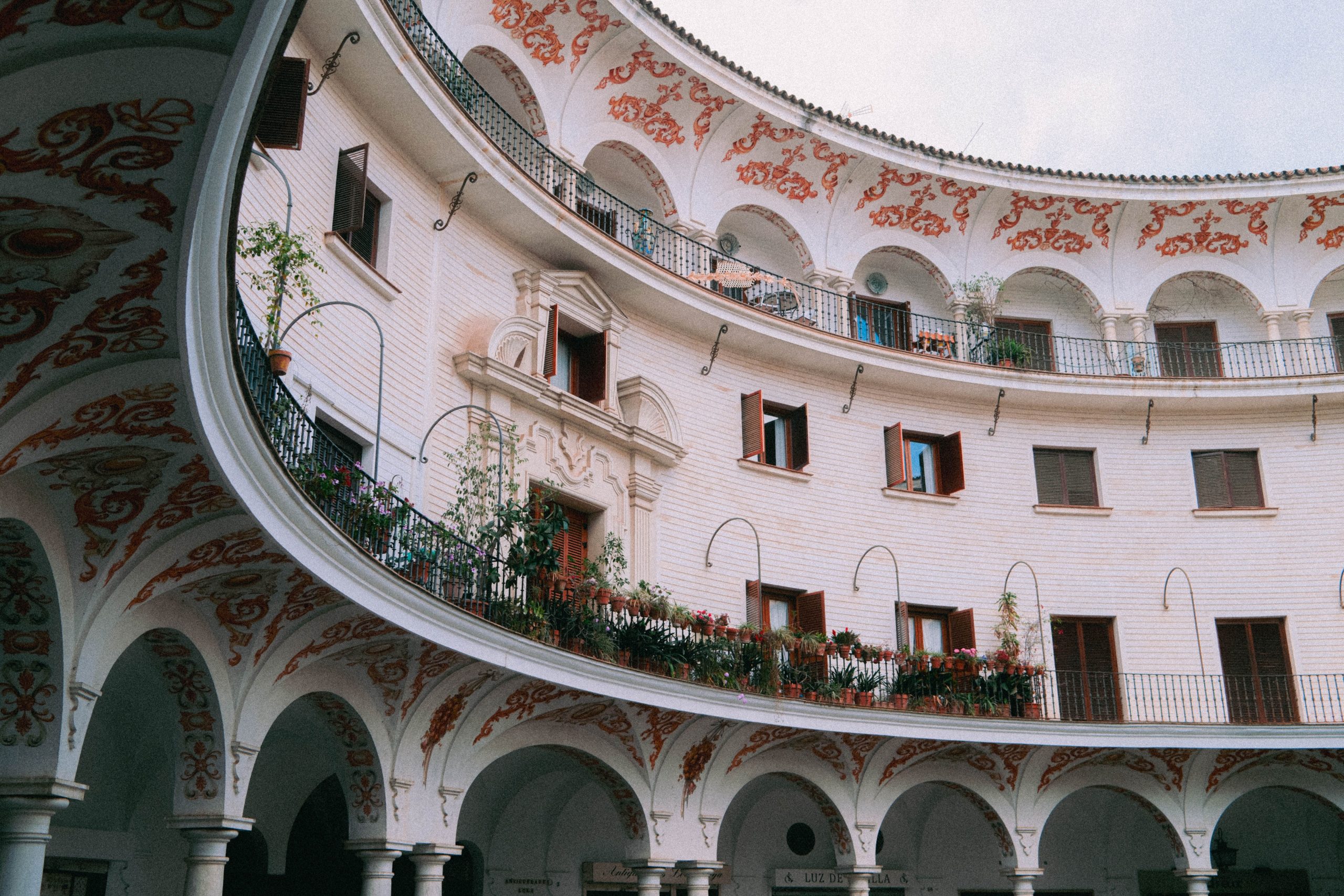 andalusia-boutique-hotel-courtyard Elegant Andalusian hotel-style courtyard with ornate arches and balconies in Seville, Spain