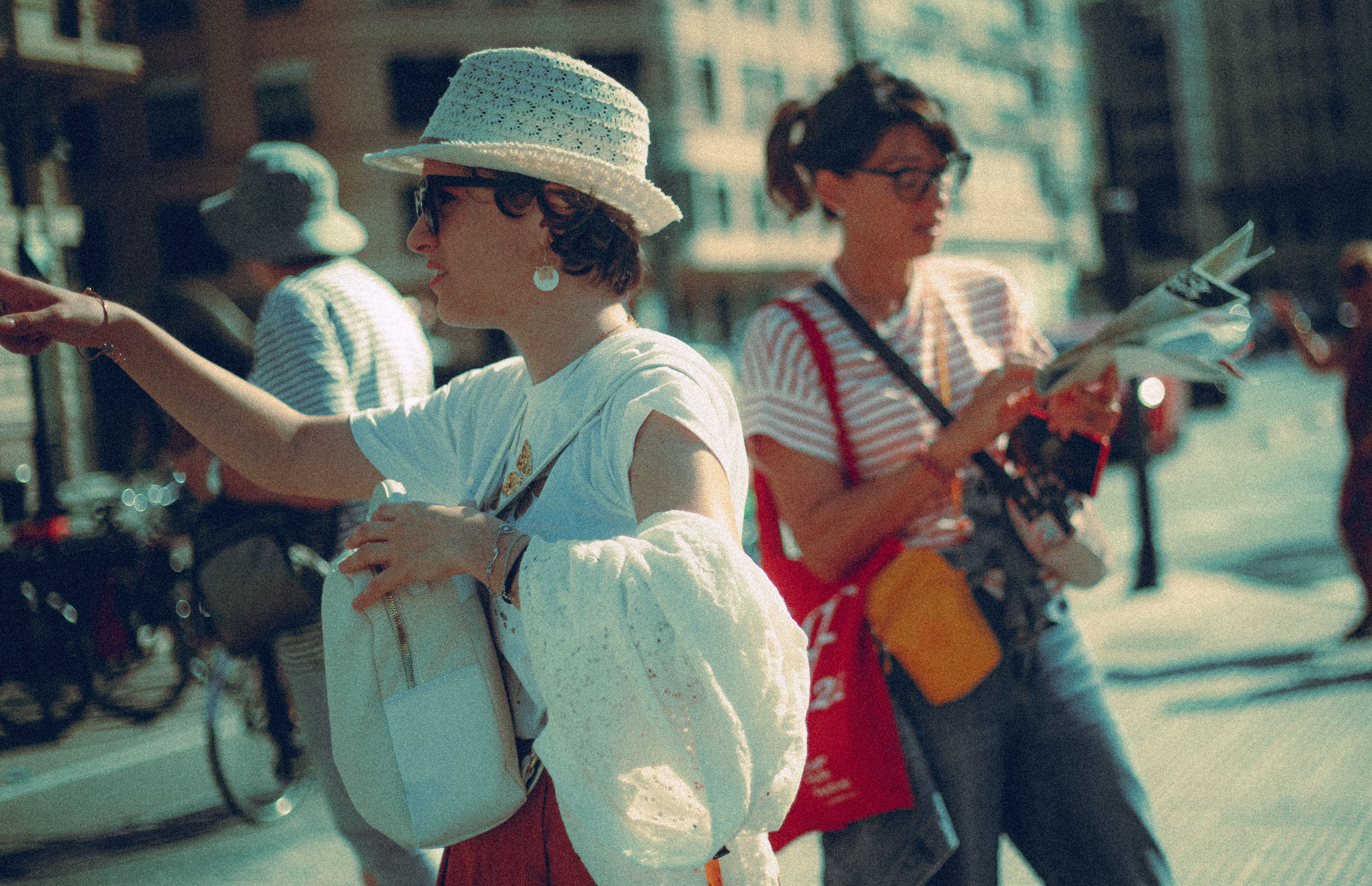 Travelers using a map while exploring a sunny Spanish city on foot
