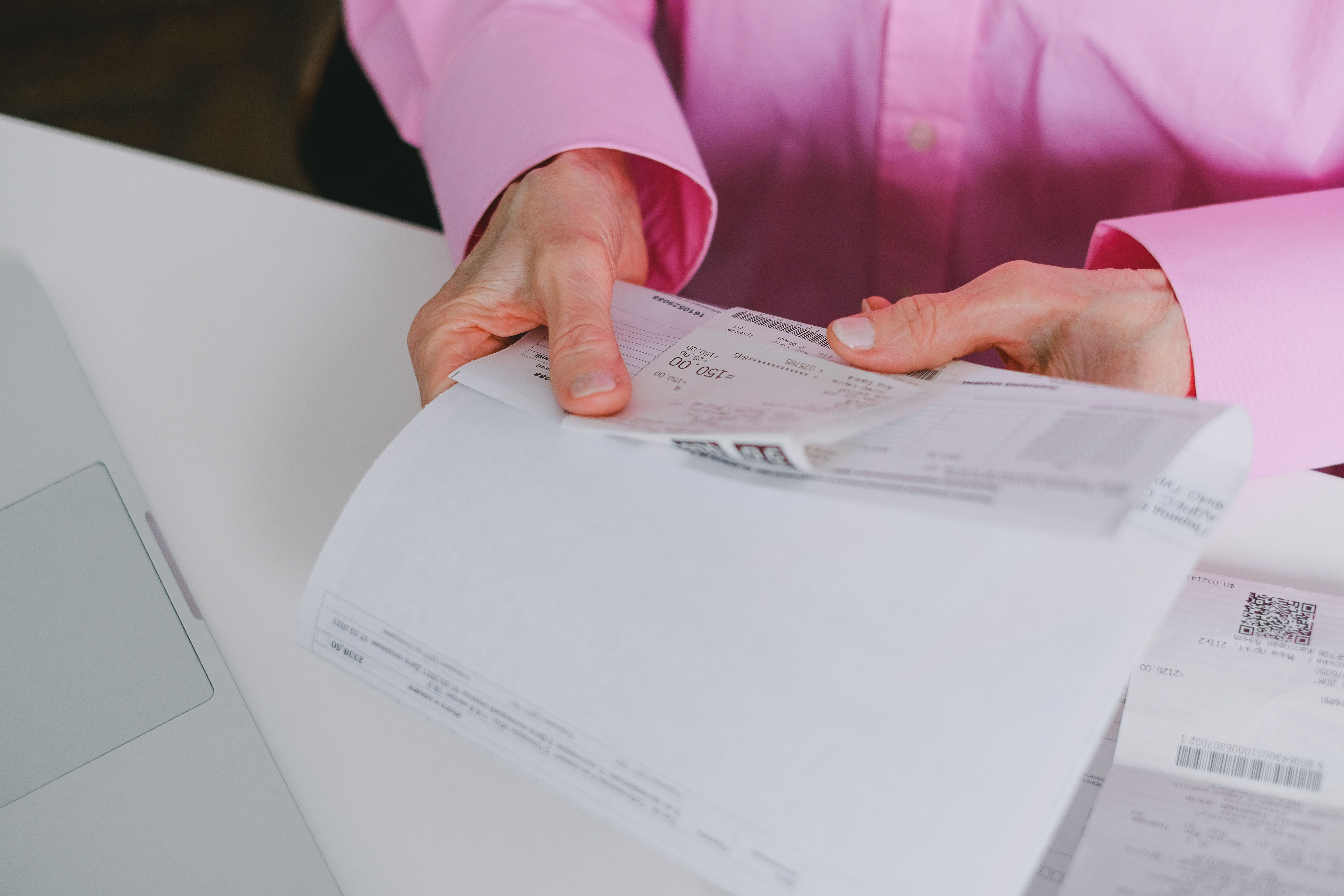 Business person organizing paper receipts for expense tracking