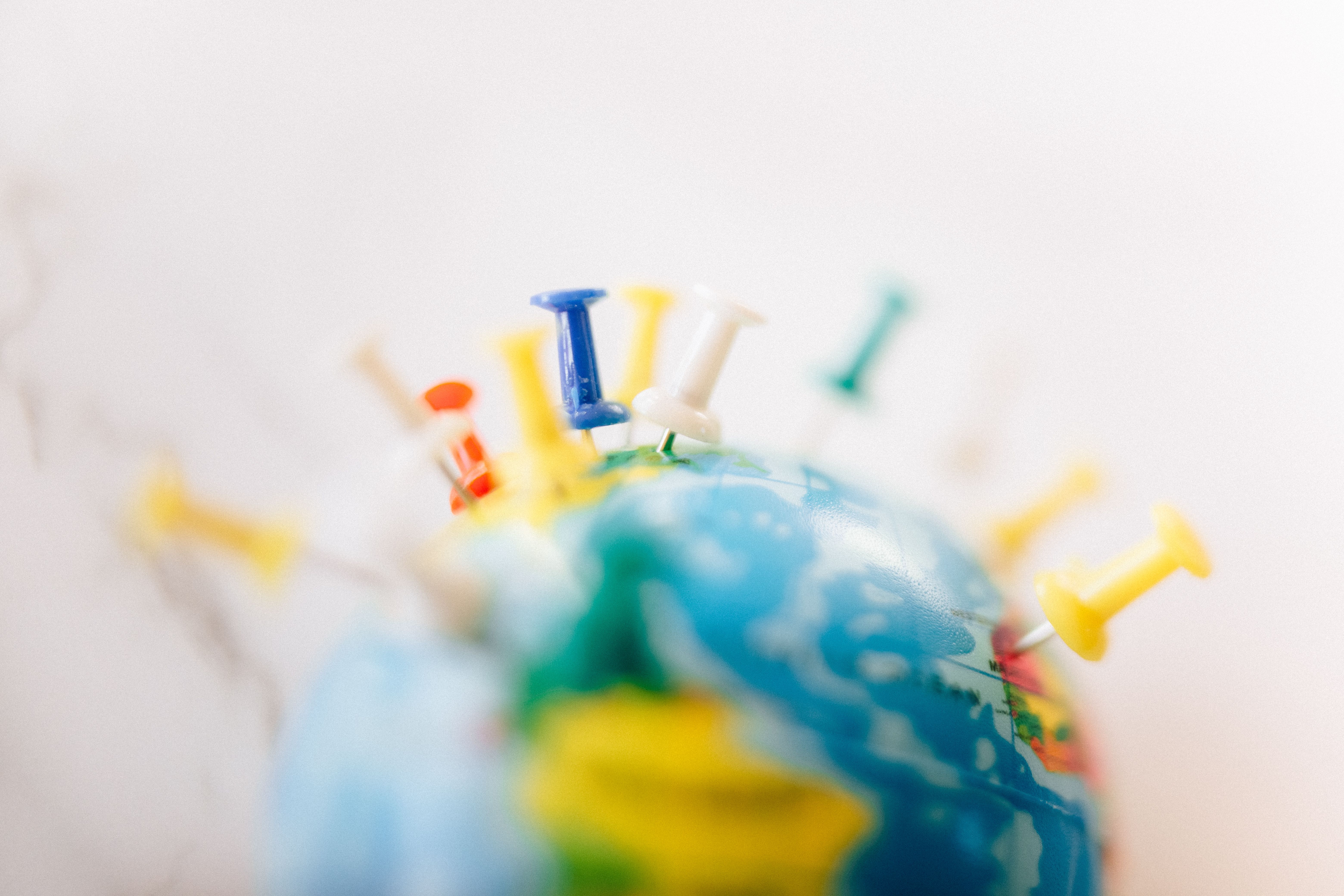 Globe marked with colorful push pins representing global connections and foreign jurisdictions