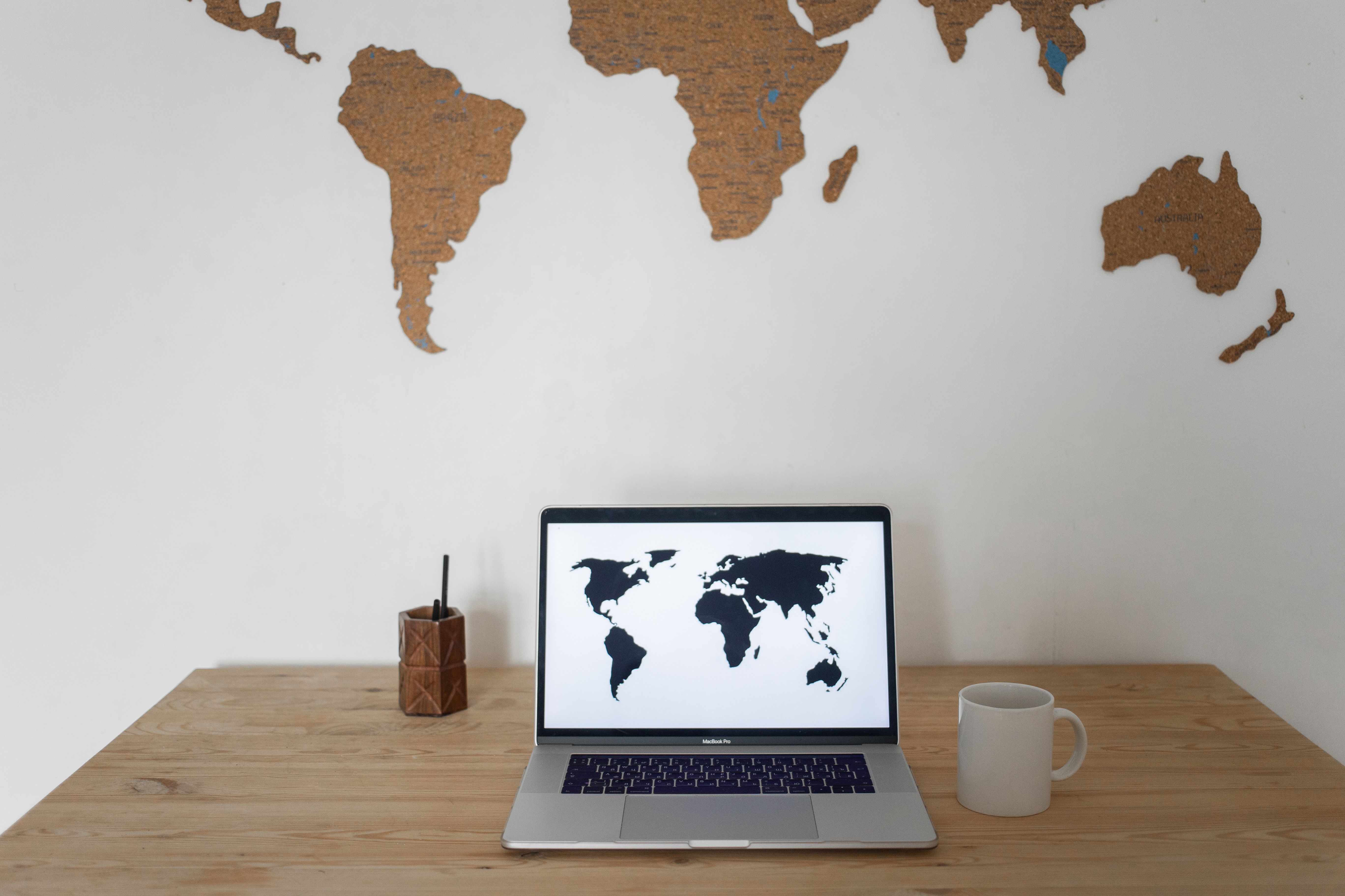 Laptop screen showing a world map symbolizing global jurisdiction in international cases