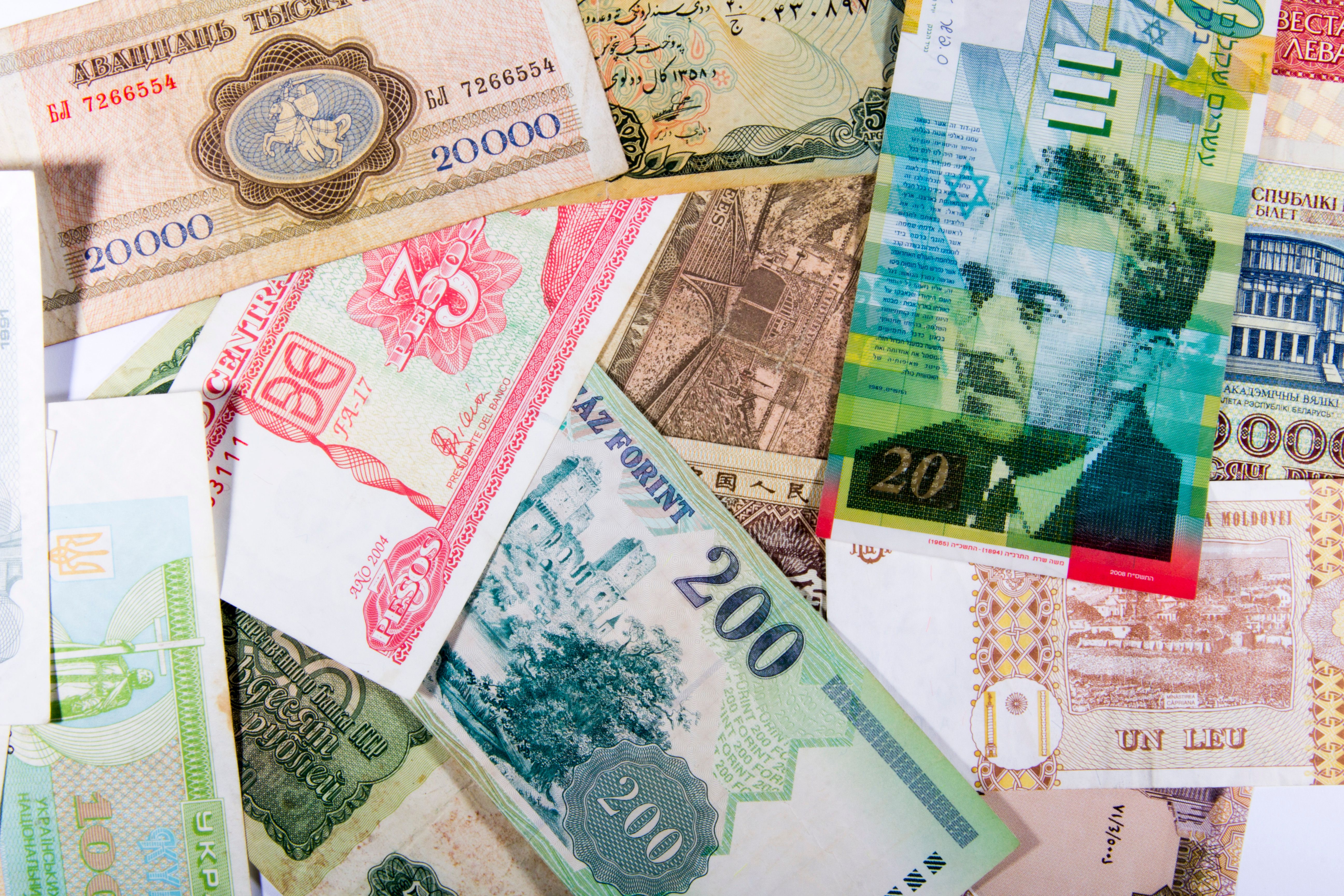 Flat lay of colorful international paper currencies from various countries