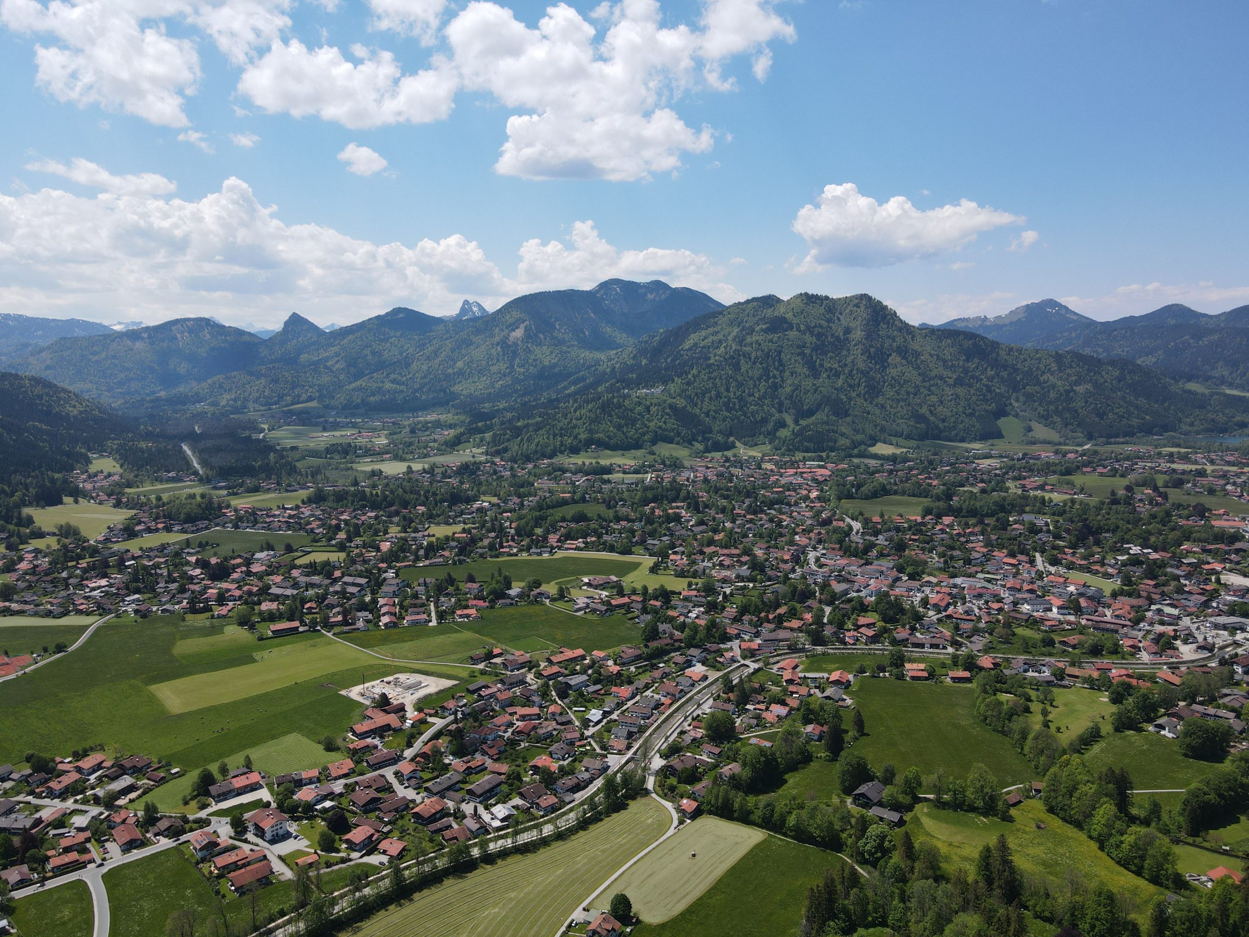 tegernsee-bavaria-luxury-lake-destination Aerial panorama of Tegernsee, Bavaria, with the lake, alpine foothills, and surrounding villages.